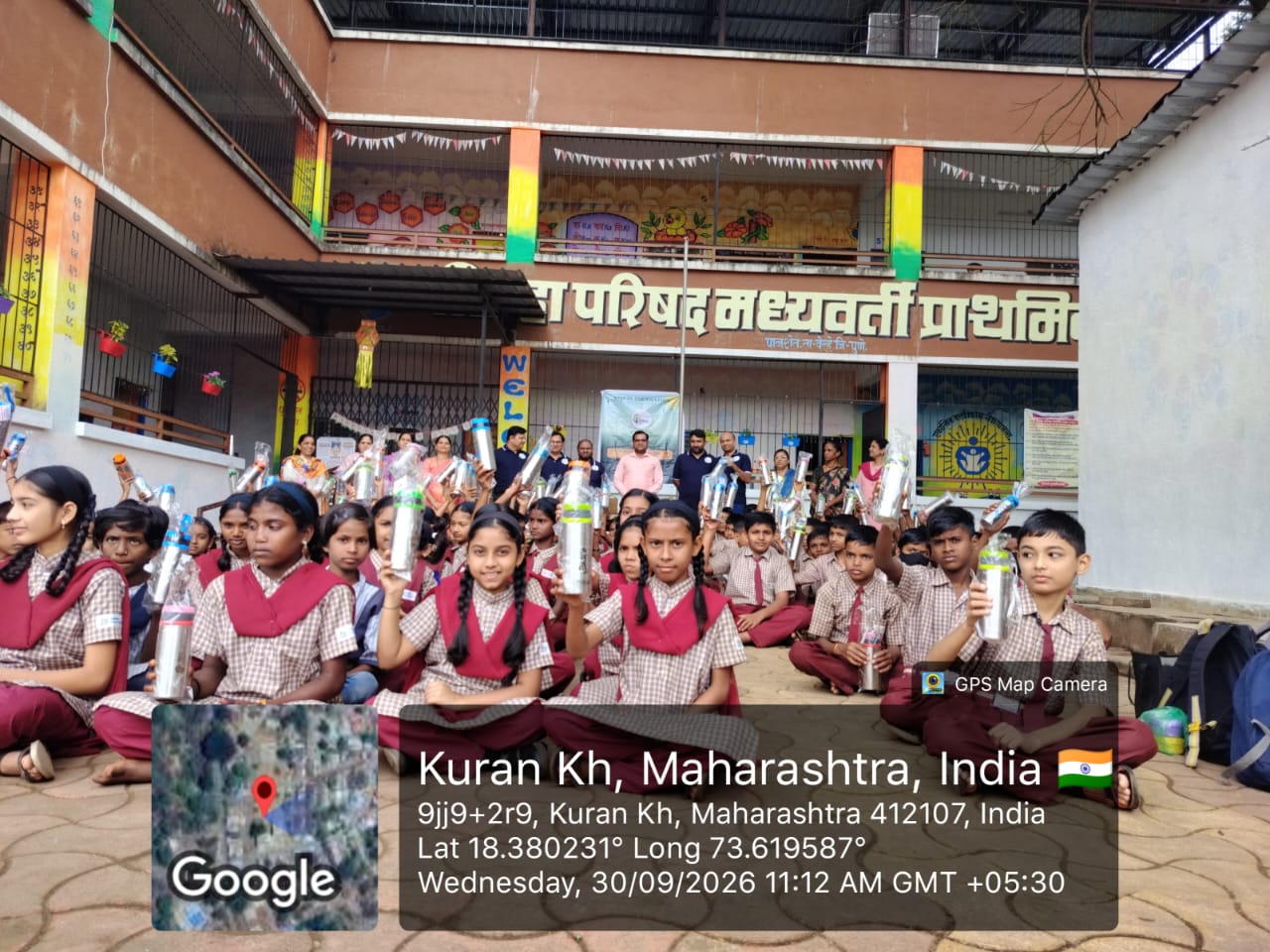 Students holding their water bottles in the school courtyard